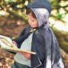 Waves and Wild Storybook Cape boy wearing grey cape reading book