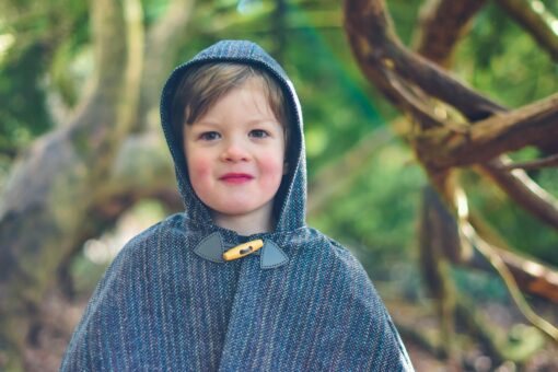 Waves and Wild Storybook Cape boy wearing grey cape with toggle fastening